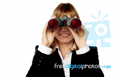 Corporate Woman Looking Through Binoculars Stock Photo