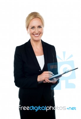 Corporate Woman Writing On Clipboard Stock Photo