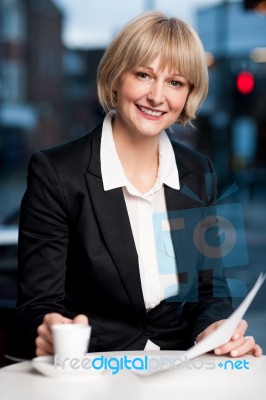 Corporate Women In Cafe With Financial Reports Stock Photo