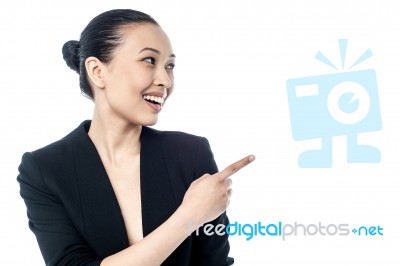 Corporate Young Woman Pointing Away Stock Photo