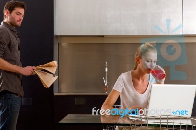 Couple At Home Using Laptop Stock Photo