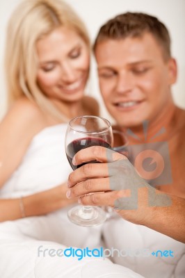 Couple Drinking Wine In Bed Stock Photo