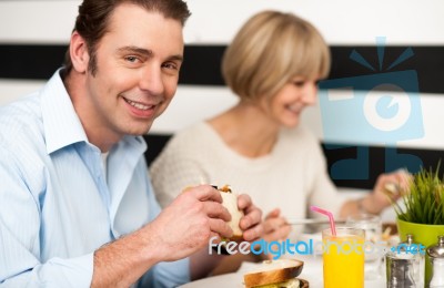 Couple Enjoying Delicious Breakfast Stock Photo