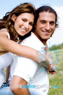 Couple Enjoying Piggyback Ride Stock Photo