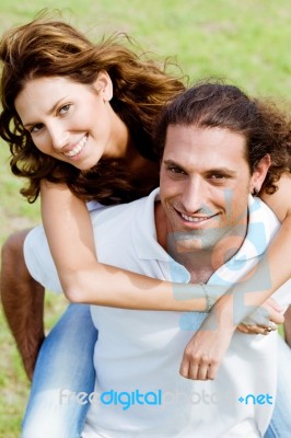 Couple Enjoying Piggyback Ride Stock Photo