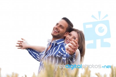 Couple Enjoying The Breeze In The Park Stock Photo