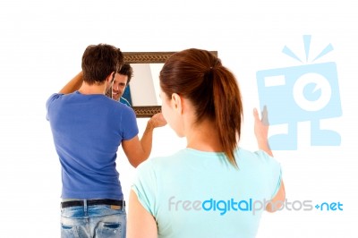 Couple Hanging A Mirror Stock Photo