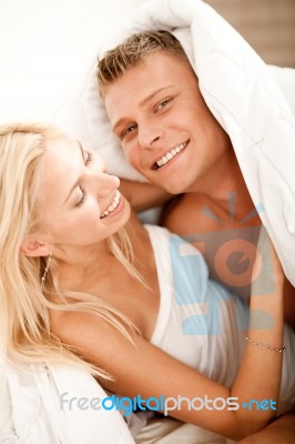 Couple Having Fun In Bed Stock Photo