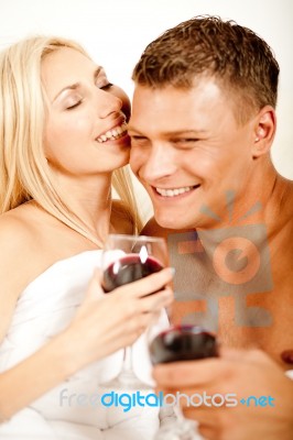 Couple In Bedroom With Wine Stock Photo