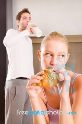 Couple In Kitchen Having Breakfast Stock Photo