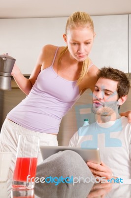 Couple In Kitchen Having Breakfast Stock Photo