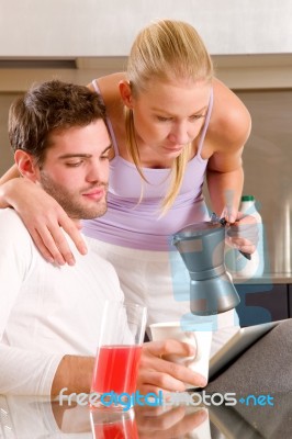 Couple In Kitchen Having Breakfast Stock Photo