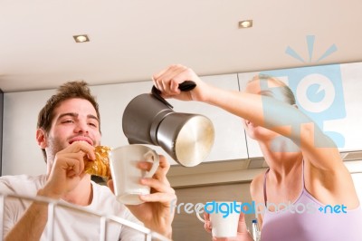 Couple In Kitchen Having Breakfast Stock Photo