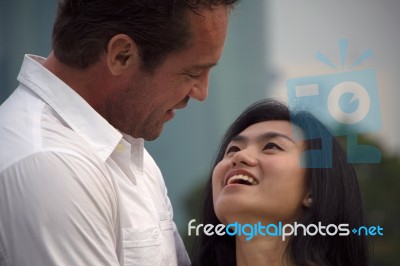 Couple In The Park Talking Stock Photo