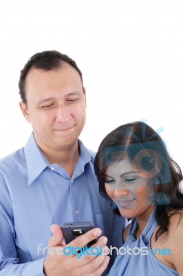 Couple Looking At A Cell Phone And Smiling Isolated On A White B… Stock Photo