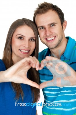 Couple Making Heart Gesture Of Love Stock Photo