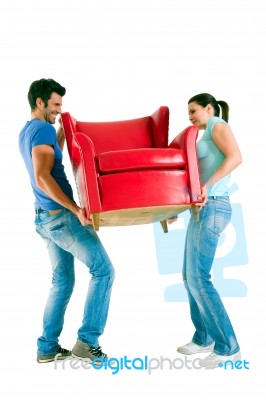 Couple Moving Armchair Stock Photo