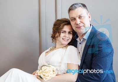 Couple Of Newlyweds Are Sitting Together Stock Photo