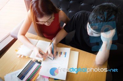 Couple Of Students In A Classroom Doing Homework Stock Photo