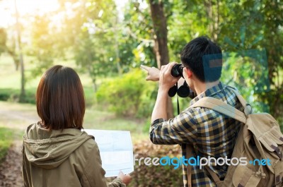 Couple Of Tourists Heading To The Forest With Maps In Hand Searc… Stock Photo