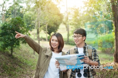 Couple Of Tourists Heading To The Forest With Maps In Hand Searc… Stock Photo