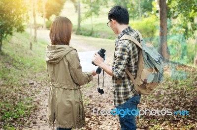 Couple Of Tourists Heading To The Forest With Maps In Hand Searc… Stock Photo