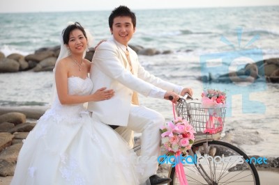 Couple Of Young Man And Woman In Wedding Suit Ridiing Old Bicycl… Stock Photo