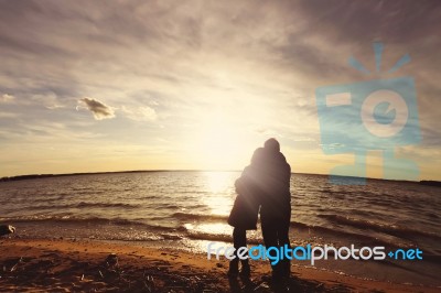 Couple On The Beach At The Sunset Stock Photo