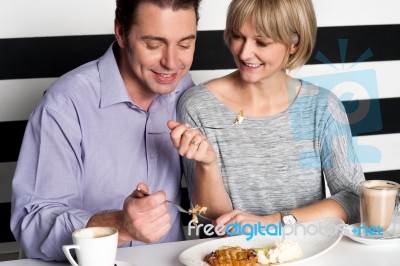 Couple Rejoicing Their Meal In Food Court Stock Photo