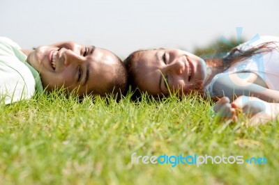 Couple Relaxing On Lawn Stock Photo