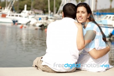 Couple Seated At Footbridge Stock Photo