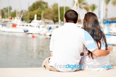 Couple Seated On Footbridge Stock Photo