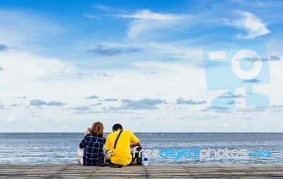 Couple Sitting And Looking The Sea Stock Photo