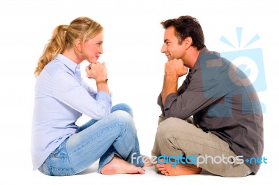 Couple Sitting Face To Face Stock Photo