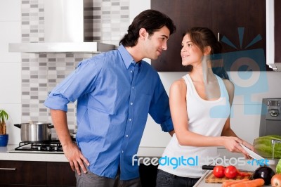 Couple Staring Each Other Eyes In The Kitchen Stock Photo