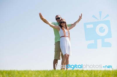 Couple Stretching Their Hands Together Stock Photo