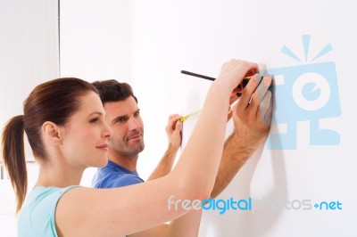 Couple Taking Measurements Stock Photo