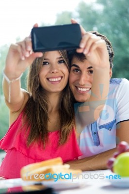 Couple Taking Photo Of Themselves With Smart Phone On Romantic P… Stock Photo