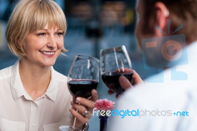 Couple Toasting In A Restaurant Stock Photo