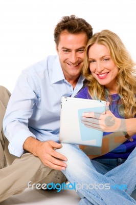 Couple Using Digital Tablet Stock Photo