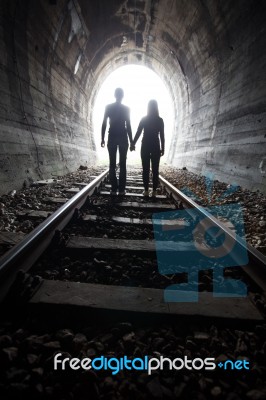 Couple Walking Together Through A Railway Tunnel Stock Photo