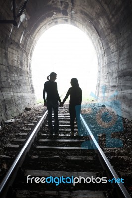 Couple Walking Together Through A Railway Tunnel Stock Photo