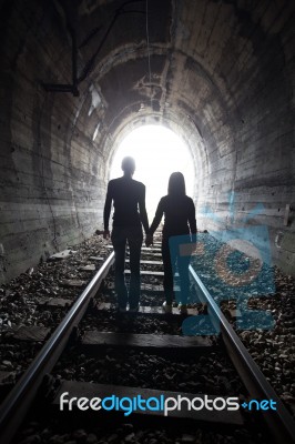 Couple Walking Together Through A Railway Tunnel Stock Photo