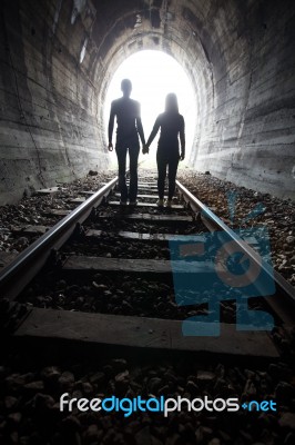 Couple Walking Together Through A Railway Tunnel Stock Photo