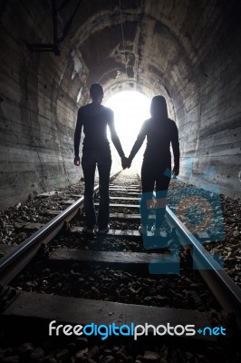 Couple Walking Together Through A Railway Tunnel Stock Photo