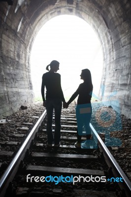 Couple Walking Together Through A Railway Tunnel Stock Photo