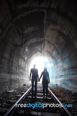 Couple Walking Together Through A Railway Tunnel Stock Photo