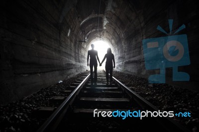 Couple Walking Together Through A Railway Tunnel Stock Photo