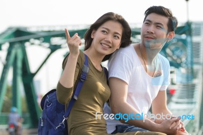 Couples Of Younger Asian Man And Woman Relaxing With Happy Face On Vacation Tirp Stock Photo