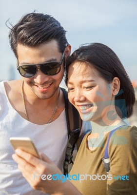 Couples Younger Asian Man And Woman Watching On Smart Phone Stock Photo